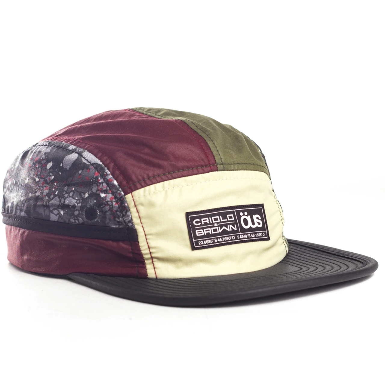 A five-panel cap in burgundy, olive and cream with a printed panel and the Criolo Brown x ÖUS label.