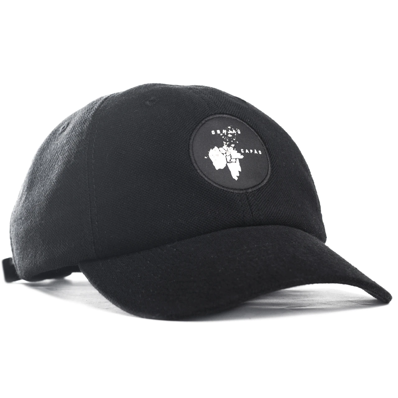 A black wool cap with a circular rubber patch badge.